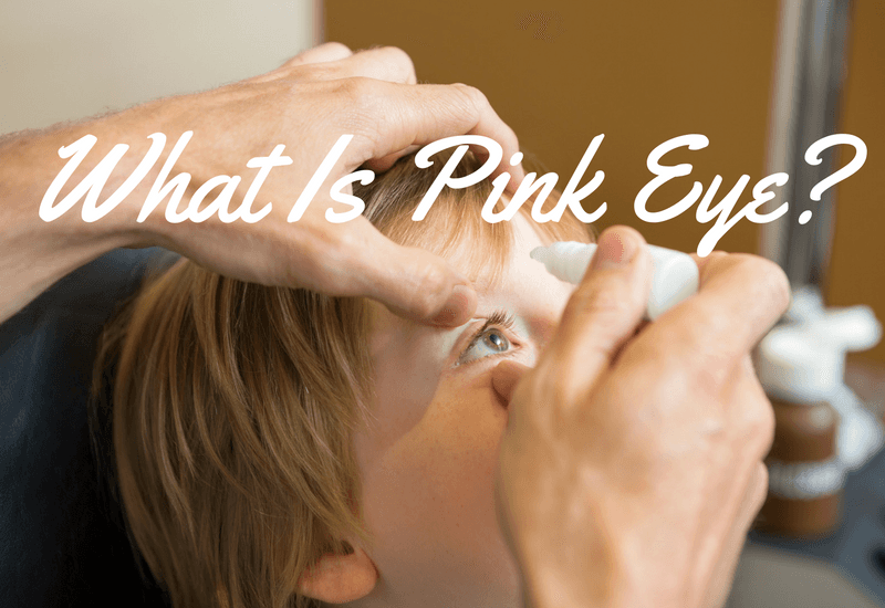 Adult putting drops in a child's eye